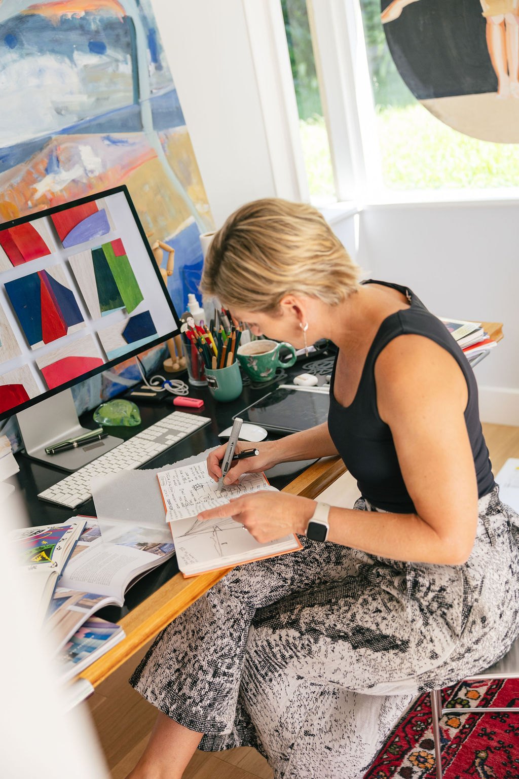 Alexandra Mowday sketching at her desk